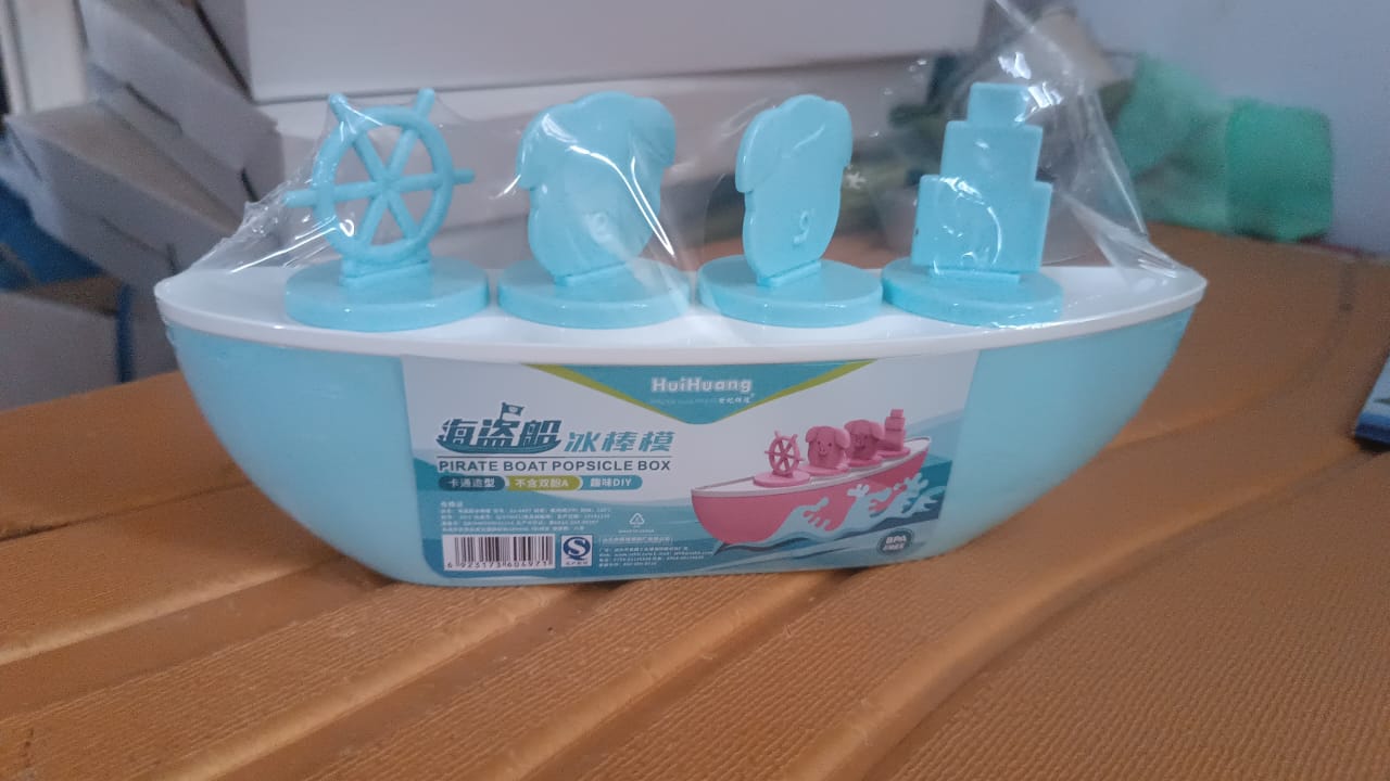 Frozen homemade popsicles made using boat-shaped ice cream mould with piggy design