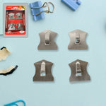 Heavy-duty self-adhesive hooks securely holding a robe, coat, and towel in a modern bathroom.