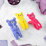 Windproof plastic towel clips holding wet clothes on a line