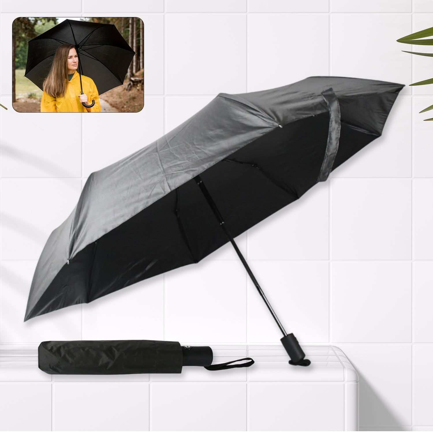 Black compact umbrella open, showcasing its sturdy steel shaft and manual operation.