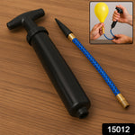 Hand holding the portable ball pump, showing its compact size.