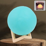 A serene blue Moon Night Lamp illuminating a dark room, creating a calming ambiance.