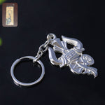 Silver metal Trishul Damru keychain shown on a white background
