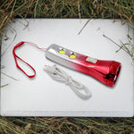Portable LED torchlight resting on a flat surface, ready for use.