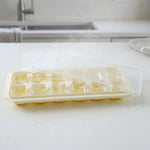 Ice cube tray with lid, perfect for making frozen treats and storing in freezer.