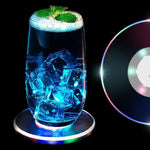 Round LED cocktail coaster switched on, displaying festive colorful lights.