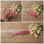Colorful silicone wrist strap keychain laid out on surface