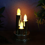 Golden candle lamp with triple LED candles illuminating festive space