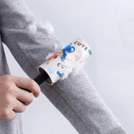 Dust remover lint roller cleaning pet hair from a fabric sofa