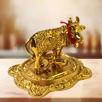 Front view of golden metal Kamdhenu Cow with calf showpiece