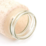 Detailed shot of the natural bamboo lid and borosilicate glass bottle.