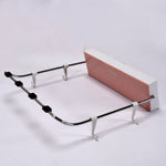 White foldable wash basin rack mounted on a wall, ready for use.