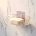Two clear plastic transparent soap holders side by side for bathroom storage