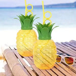 Top-down view of the pineapple cup with its green leaf lid and reusable straw.