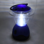 Person holding the compact Indo Glow Mini Camping Lantern, showcasing its portable design.