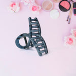 Close-up of matte plastic hair barrette clamp open
