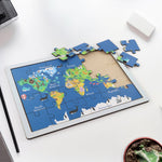 Completed wooden world map puzzle showing continents, animals, and landmarks.