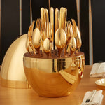 Golden spoons neatly placed within the elegant oval cutlery stand.