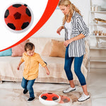 Child playing with soft kick hover soccer ball indoors
