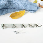 Polished stainless steel 5-hook rack holding towels and kitchen utensils
