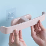 Close-up of the durable PP material self-adhesive towel rack holding neatly folded bath towels.