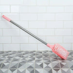 Angled shot of long handle toilet cleaning brush designed for bathroom use