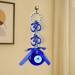 Detailed view of double OM evil eye hanging with beads and ribbon