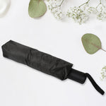 Compact umbrella easily sliding into a backpack pocket, highlighting its portability.