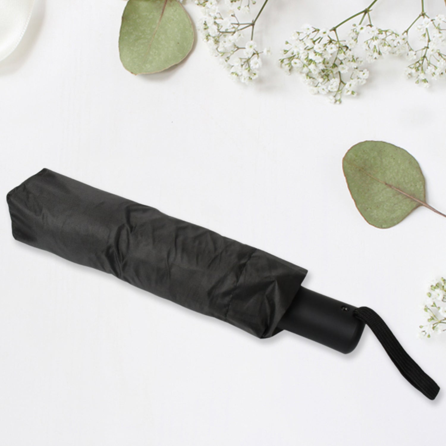 Compact umbrella easily sliding into a backpack pocket, highlighting its portability.