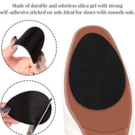 Hand demonstrating the easy application of anti-slip shoe stickers onto a high heel's sole.