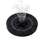 The solar floating water fountain demonstrating a wide, gentle spray pattern in a garden pool.