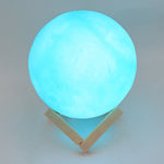 An elegant blue Moon Night Lamp casting a gentle glow, perfect for a cozy corner.