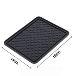 The non-slip anti-skid mat demonstrated holding small items firmly in place.