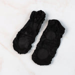 Pair of no-show liner socks laid flat, showing minimal coverage