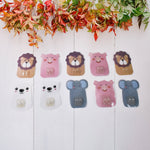 Fun and colorful cartoon hooks mounted on the wall for kids' playroom