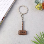 Side perspective of metal hammer keychain showing thickness