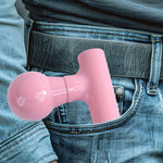 Hand holding the black mini massager, demonstrating ease of use.