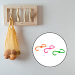 Plastic S hooks holding clothes and accessories neatly
