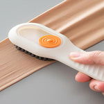 Liquid dispensing brush effectively cleaning a pair of shoes.