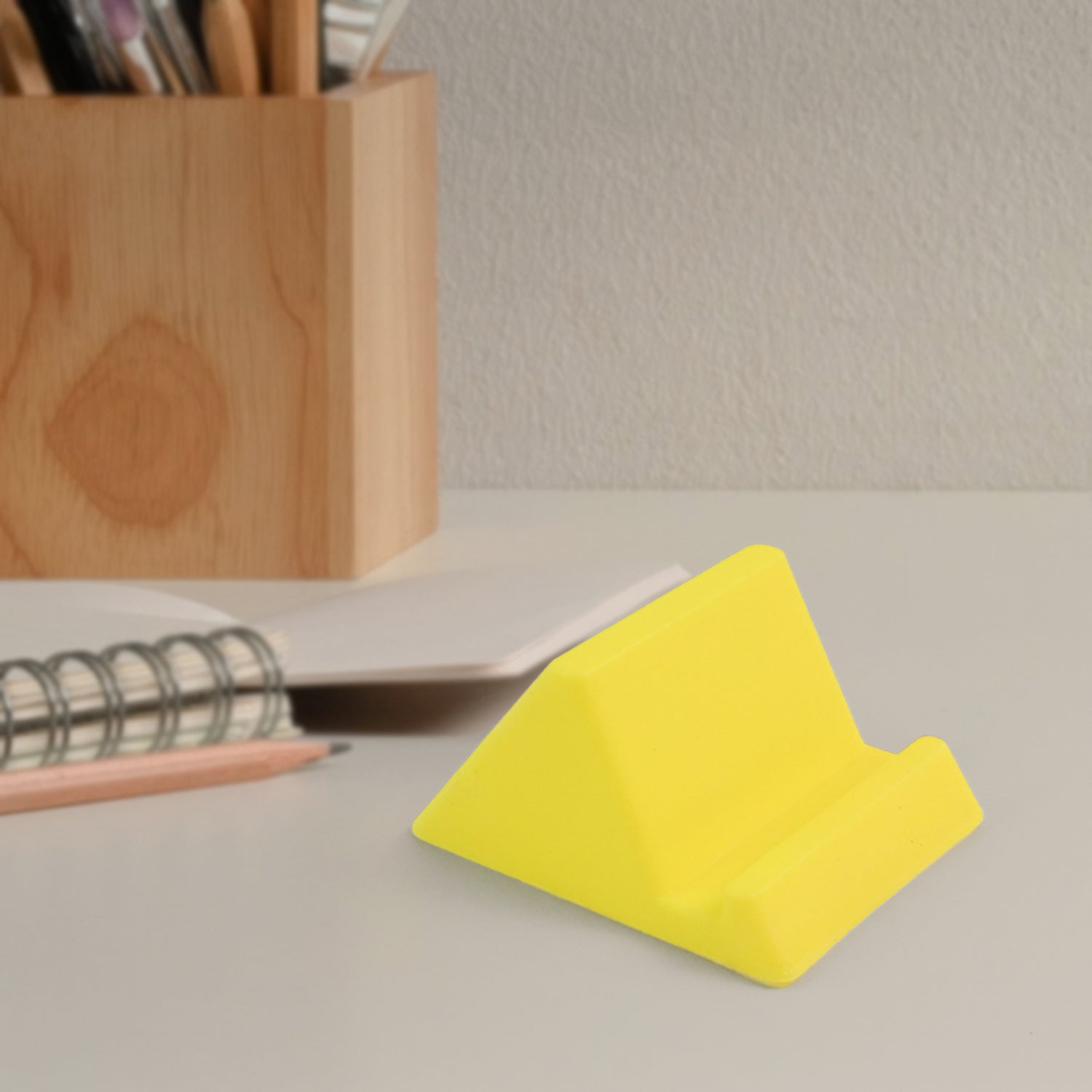 Lightweight plastic mobile phone holder designed for desktop use and video watching