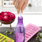 Several clear ice cubes from the ice tray chilling a refreshing drink in a glass.