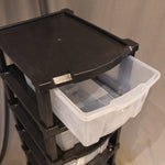 Close-up of flexible clear organizer drawers in plastic storage cabinet