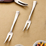 Close-up view of stainless steel fruit fork picking a piece of fruit