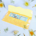 A neat stack of multicoloured premium cash gift envelopes with elegant purse handles.