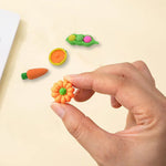 Brightly colored cute erasers arranged for a fun display on a white background.