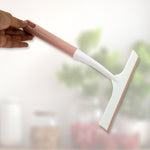 A hand demonstrating the small detailing brush for intricate cleaning tasks.