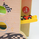 Top-down view of the wooden ramp racer track with cars ready for a race.