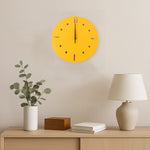 Side view of yellow round wall clock showing slim profile