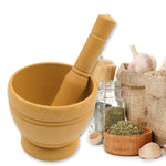 Mortar and pestle set displayed with fresh herbs and measuring spoons.
