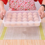 Clear plastic egg container holding 24 eggs viewed from above